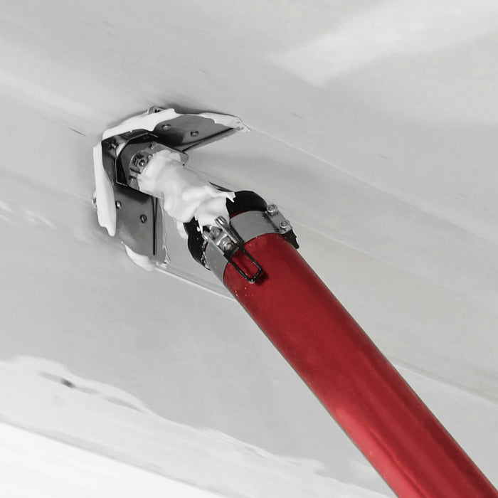 Close-up of red Level 5 Compound Applicator Tube with corner flusher attachment filling and feathering a taped corner with mud